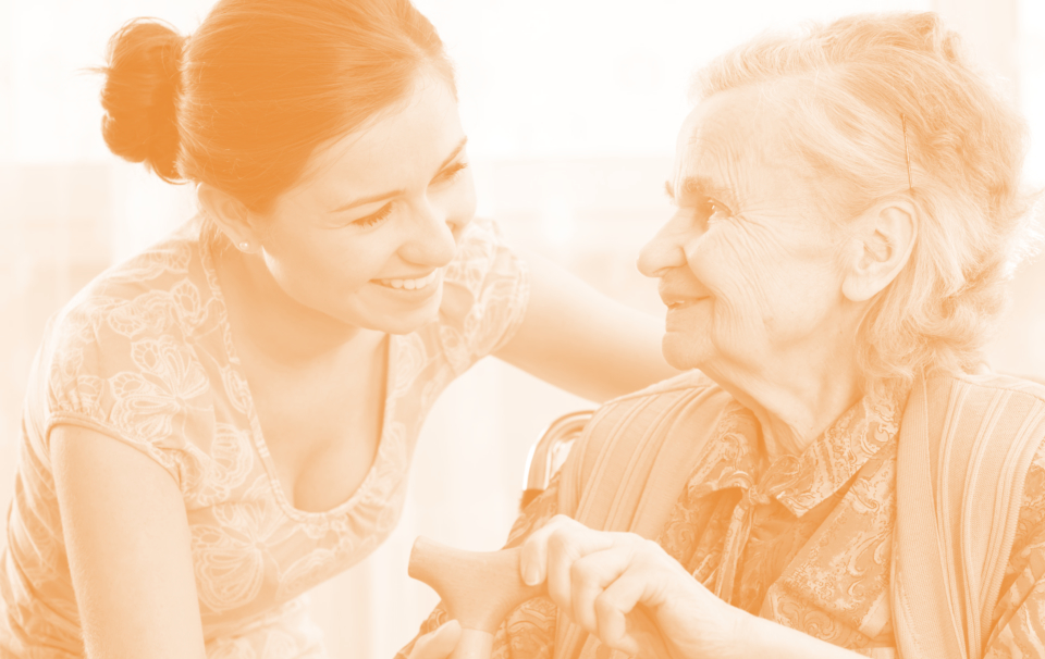 caregiver and elder woman smiling